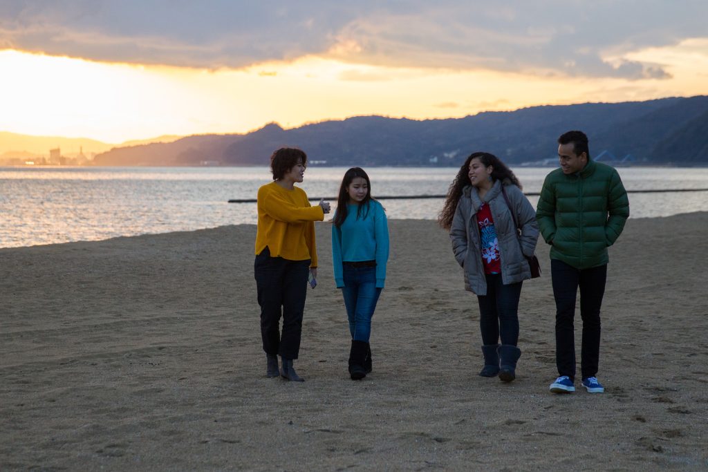 friends walking on beach in Beppu 